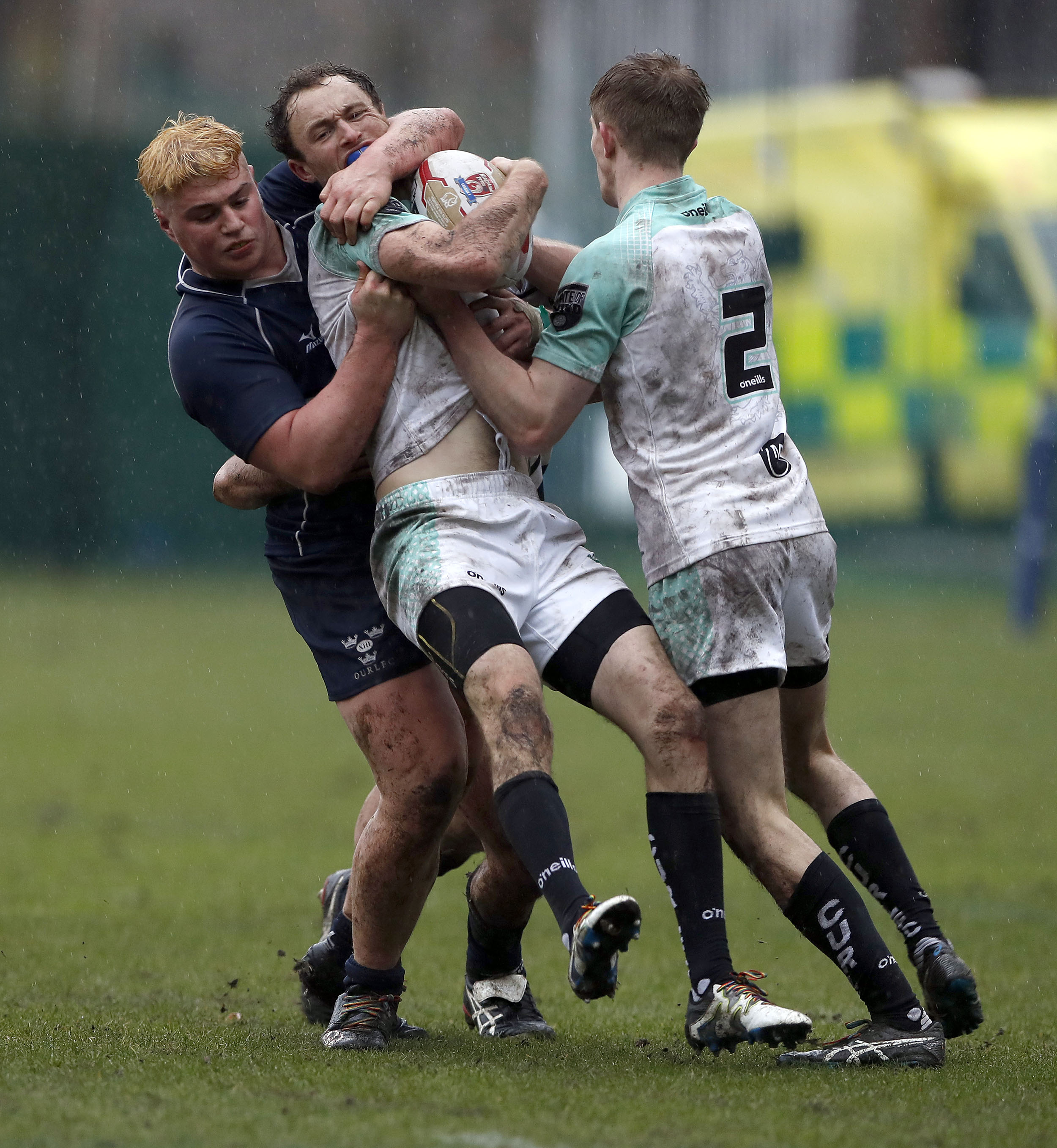 Craig Winfield of Cambridge is tackled by Sven Kerneis (L) during the RCMA Varsity Rugby League game between Cambridge University and Oxford University at the HAC Ground, Moorgate, London on Fri Mar 9, 2018
